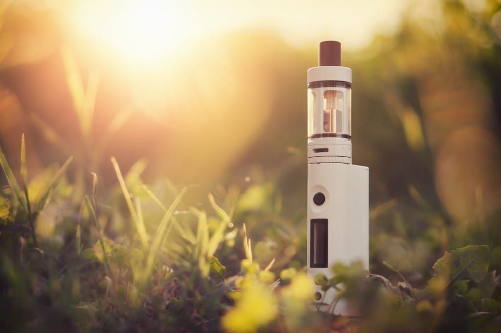 Adjustable electronic cigarette, Non carcinogenic alternative for smoking, sunset in the background