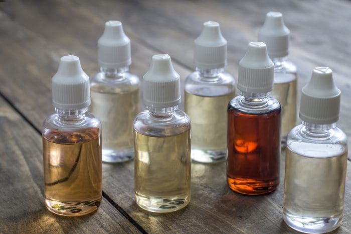 Different re-fill bottles for e-cigarettes, close up
