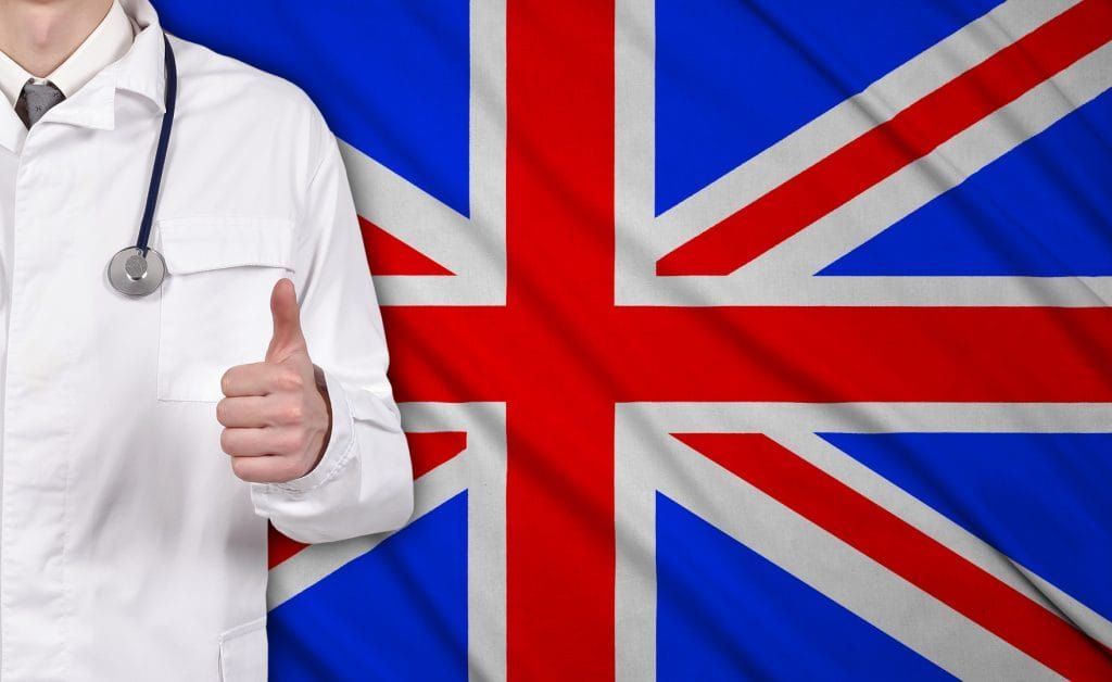 British doctors finally support e-cigarettes doctor showing thumb up on a United Kingdom flag on background