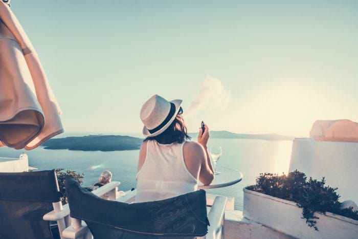 Lady Enjoying the Santorini sunset with her vape