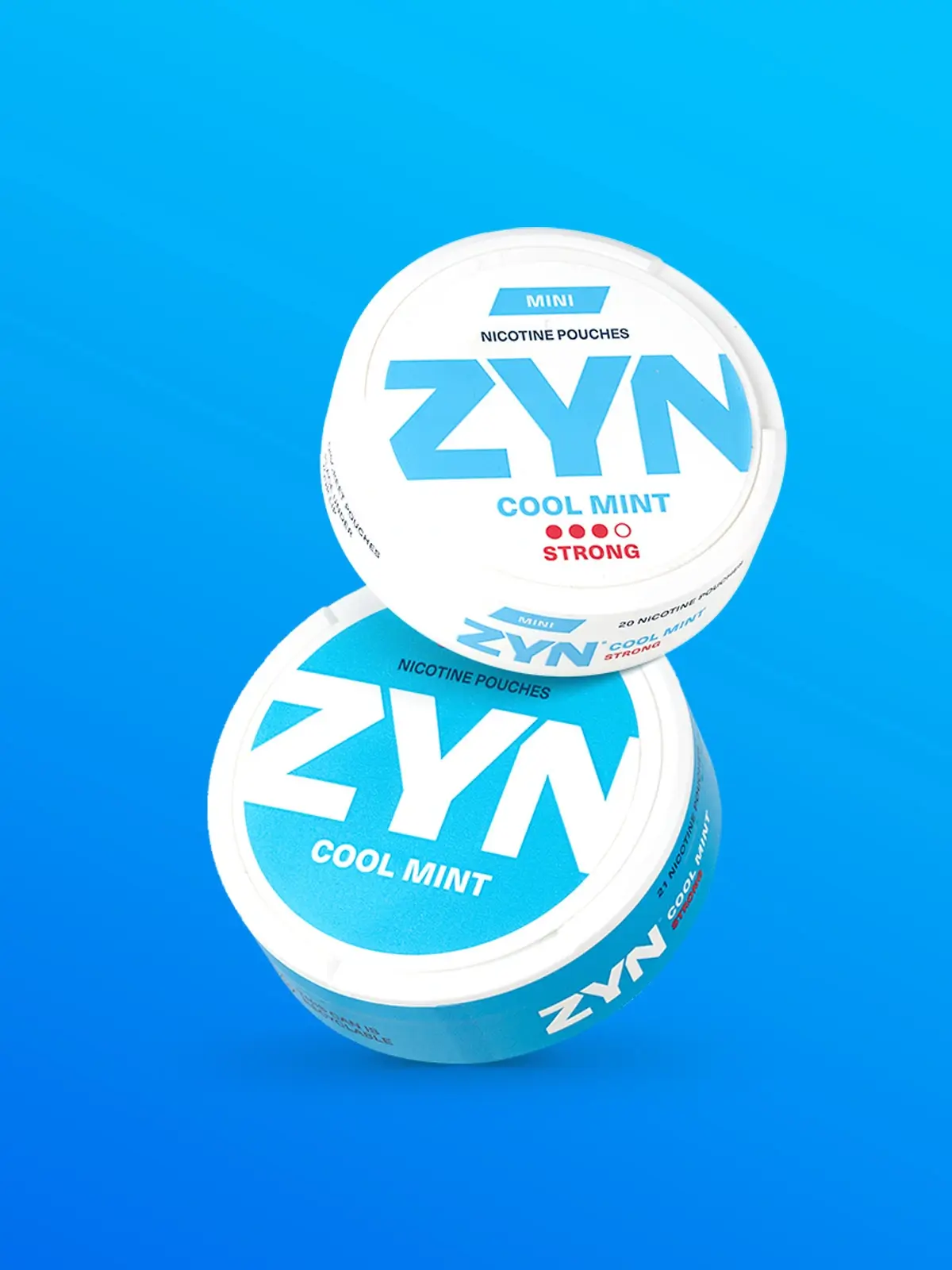 Two cans of ZYN nicotine pouches in Cool Mint with one being the Mini variety, in front of a blue background