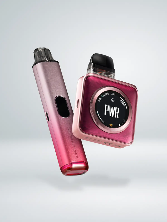One pink-gradient Vaporesso Vibe kit, and one pink Vaporesso XROS 5 Nano kit, floating side by side on a white background