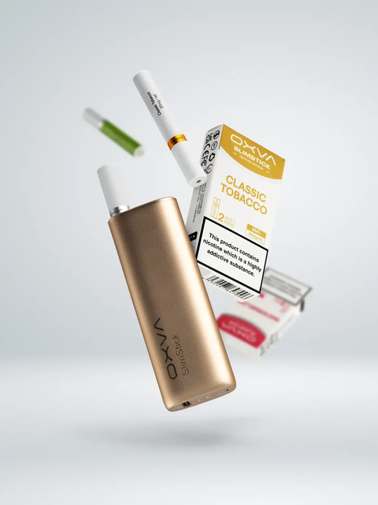 A gold OXVA Slim Stick kit floating next to a pack of Classic Tobacco Slim Stick refills on a white background