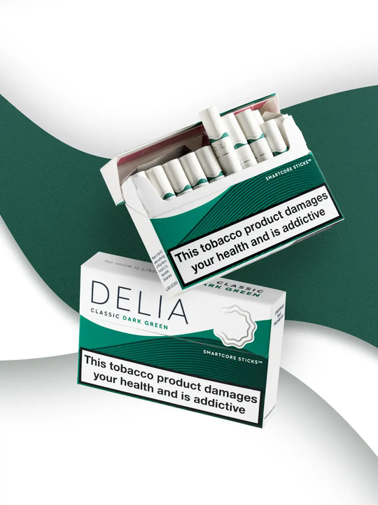 Two packs of IQOS DELIA Classic Dark Green sticks, one pack closed, the other pack open with tobacco sticks visisble.