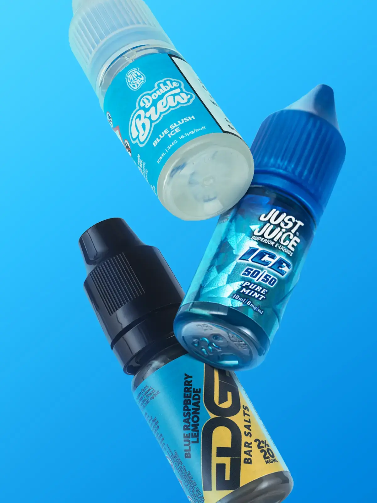 Three bottles of nicotine salt e-liquid floating in front of a blue background; Ohm Brew's Blue Slush Ice from their Double Brew range, Juice Juice Pure Mint from their ICE range and Edge Blue Raspberry Lemonade from their Bar Salts range